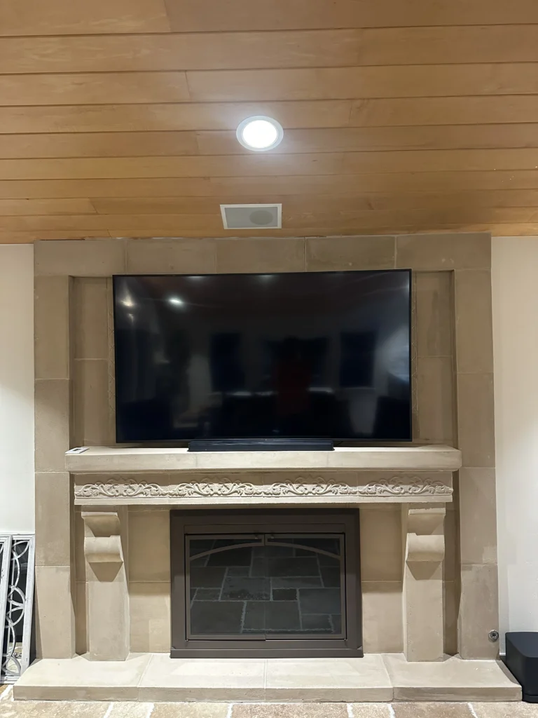 TV above a stone fireplace