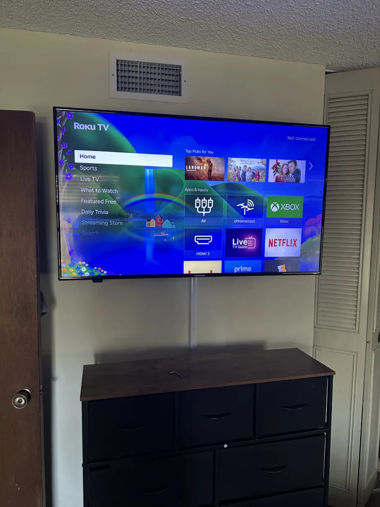 TV mounted above a dresser