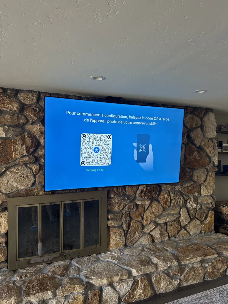 TV mounted on a river rock fireplace wall