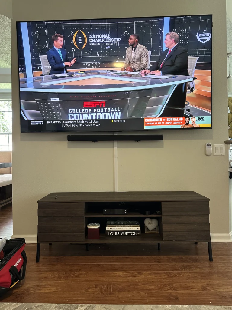 TV and soundbar above a media console